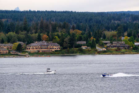 Campbell River, Vancouver Island, British Columbia, Canada. View of Fishing Boat with residential...
