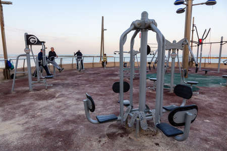 Netanya, Israel - April 3, 2019: Outdoor gym at the beach during a vibrant sunny sunrise.のeditorial素材