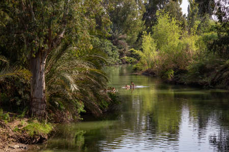 Jordan River, Israel - April 9, 2019: People swimming in the beautiful river during a sunny day.のeditorial素材
