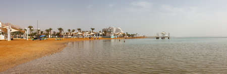 Ein Bokek, Israel - April 7, 2019: Panoramic view of the sandy beach near the Vacation Resorts at the Dead Sea.のeditorial素材