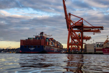 Vancouver, BC, Canada - December 25, 2018: Big cargo ship at the port during a vibrant winter...