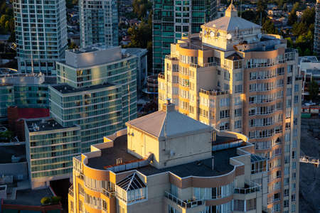 Burnaby, Vancouver, BC, Canada - July 12, 2018: Aerial view of a modern city during a vibrant sunset.のeditorial素材