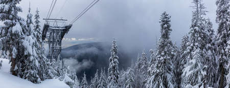 Beautiful Panoramic view of a Gondola during a vibrant winter sunset. Taken in Grouse Mountain, North Vancouver, BC, Canada.の写真素材