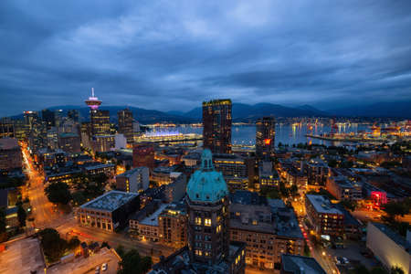 Downtown Vancouver, British Columbia, Canada - June 22, 2018: Aerial view of the modern city during night time after a cloudy sunset.のeditorial素材
