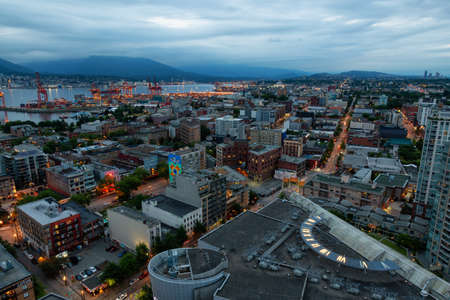 Downtown Vancouver, British Columbia, Canada - June 22, 2018: Aerial view of the modern city during night time after a cloudy sunset.のeditorial素材