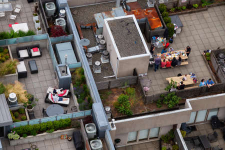 Downtown Vancouver, British Columbia, Canada - June 22, 2018: Aerial view from above of people enjoying a summer evening on top of the roof.のeditorial素材
