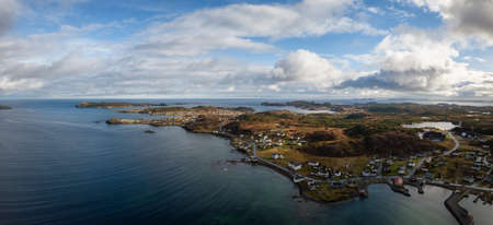 Aerial view of a small town on a rocky Atlantic Ocean Coast during a cloudy day. Taken in Twillingate, Newfoundland, Canada.の写真素材