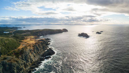 Aerial view of a rocky Atlantic Ocean Coast during a cloudy sunset. Taken in Twillingate,...
