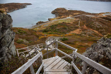 Wooden stairs going up a rocky cliff on the Atlantic Ocean Coast during a cloudy day. Taken at Dare...