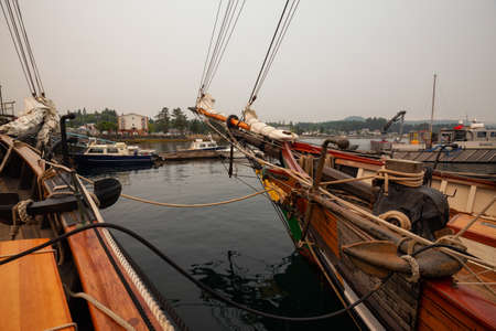 Port Hardy, Vancouver Island, BC, Canada - August 20, 2018: Wooden sailboat parked at a marina during a foggy summer day.のeditorial素材
