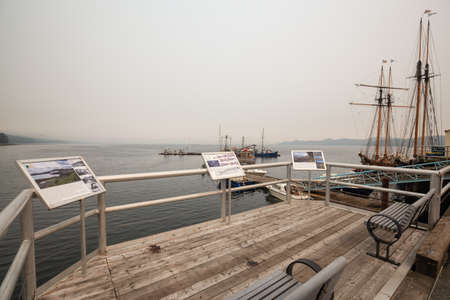 Port Hardy, Vancouver Island, BC, Canada - August 20, 2018: Wooden viewpoint at a marina during a...