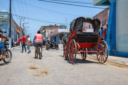 Cardenas, Cuba - May 11, 2018: Horse Carriage riding in the streets of an Old Cuban Town near Varadero during a sunny day.のeditorial素材