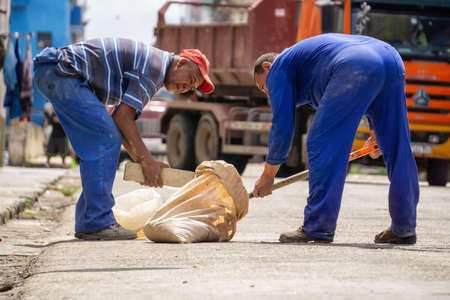 Havana, Cuba - May 16, 2019: Man doing labour work in the streets of Old Havana City during a hot sunny day.のeditorial素材