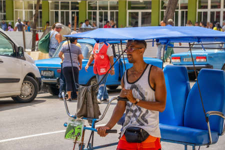 Havana, Cuba - May 16, 2019: Bicycle Taxi Driver in the street of Old Havana City during a vibrant and bright sunny day.のeditorial素材
