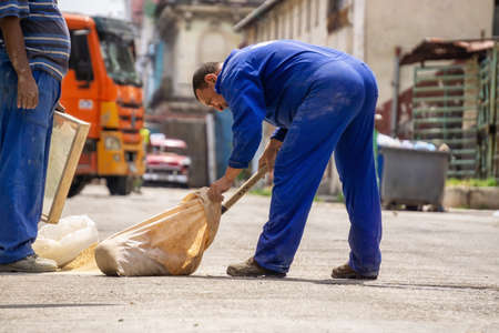Havana, Cuba - May 16, 2019: Man doing labour work in the streets of Old Havana City during a hot sunny day.のeditorial素材
