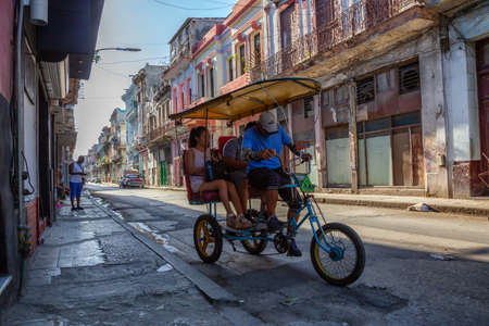 Havana, Cuba - May 13, 2019: Bicycle Taxi Driver riding in the streets of Old Havana City during a vibrant and bright sunny morning.のeditorial素材