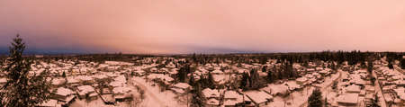 Aerial Panoramic View of a Residential Neighborhood with homes in white after a big snow storm in the Lower Mainland during sunset. Taken Greater Vancouver, BC, Canada.の写真素材