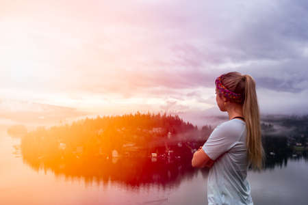 Adventurous Girl at the Lookout of a Famous Hike to Quarry Rock. Taken in Deep Cove, North...