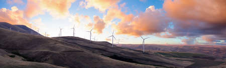 Beautiful Panoramic Landscape View of Wind Turbines on a Windy Hill during a colorful sunrise. Taken in Washington State, United States of America.の写真素材