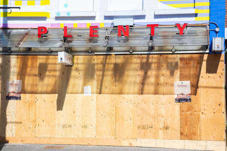 Vancouver, British Columbia, Canada - April 16, 2020: Stores closed and borded in the downtown city...