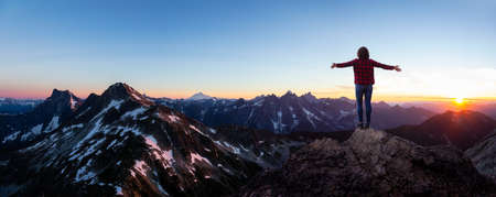Fantasy Adventure Composite of Girl with Hands Open and Panoramic Canadian Landscape in background during a vibrant sunset. British Columbia, Canada. Panoramaの写真素材
