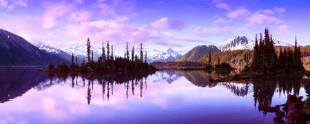 Garibaldi Lake during a colorful morning sunrise. Cloudy Sky Composite. Panoramic Canadian Mountain Landscape. Located near Whistler, Squamish and Vancouver, BC, Canada.の写真素材
