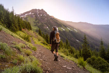 Adventurous Man Hiking in the Canadian Mountains during a sunny summer morning. Taken on the Trail...