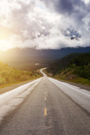 Beautiful View of a scenic road in the Northern Rockies during a sunny and cloudy morning. Taken in British Columbia, Canada. Nature Backgroundの写真素材