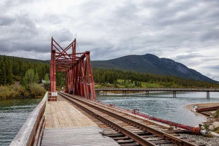 Carcross, Yukon, Canada - August 23, 2020: Historic Train Bridge in a small touristic town.のeditorial素材