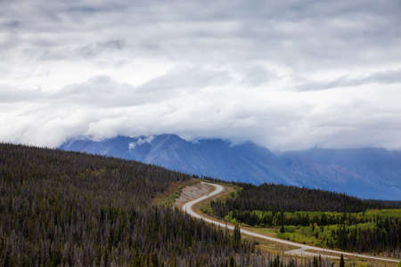 Scenic Route, Alaska Hwy, during a sunny and cloudy day. West of Whitehorse, Yukon, Canada.