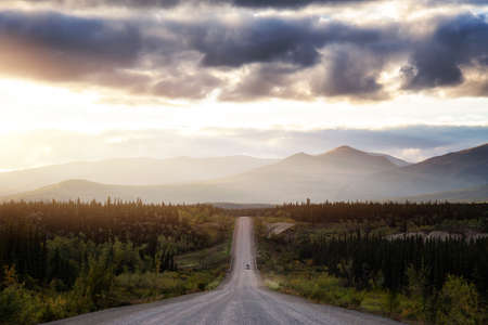 Scenic Route, Alaska Hwy, during a dramatic sunset. Mountains in Background. West of Whitehorse, Yukon, Canada.の写真素材