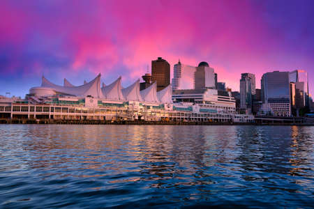 Canada Place and commercial buildings in Downtown Vancouver Viewed from water during sunset. British Columbia, Canada.の写真素材