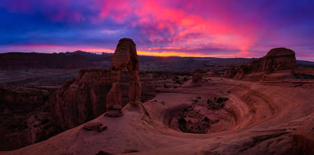 Beautiful panoramic landscape of the unique sandstone rock formation in the desert. Dramatic Colorful Sunset Artistic Render. Taken in Arches National Park, Moab, Utah, United States.の写真素材