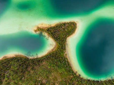 Aerial view of colorful pond in the marshlands during a fall season day. Taken in Yukon, Canada.