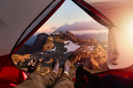 Camping inside a Tent with beautiful rocky mountains in the background. Adventure Composite....