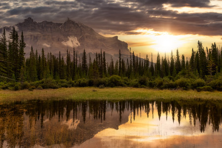 Beautiful Canadian Nature landscape view of a Lake in Banff National Park, Alberta, Canada. Dramatic Colorful Stormy Sunset Sky. Scenic Backgroundの写真素材