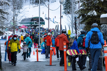 Whistler, British Columbia, Canada - December 28, 2020: Busy line up of people waiting for gondola to go ski and snowboard up the mountain during the Holiday Season.のeditorial素材