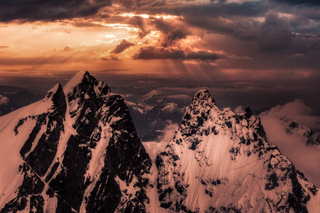 Dramatic Artwork. Aerial landscape view of the snow covered mountain range near Chilliwack and Vancouver, British Columbia, Canada. Artistic Sunset Sky Renderの写真素材