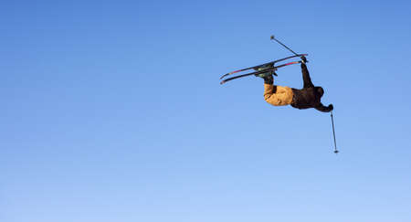 whistler, British Columbia, Canada - Jan 18, 2021: Extreme Skier jumps up high with blue sunny sky in background.のeditorial素材