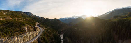 Aerial drone view of Sea to Sky Highway during a bright winter sunset. Taken between Squamish and Whistler, North of Vancouver, British Columbia, Canada.の写真素材