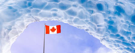 Beautiful View of the Ice Cave in the Alpines with Canadian Flagの写真素材