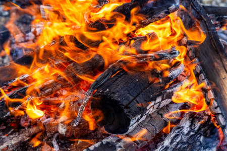 Close up picture of wood burning in a camp fire. Hot Red Flames. Taken in British Columbia, Canada.の写真素材