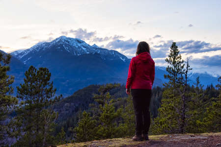 Adventurous Woman Hiking in the mountains during a Spring Sunset. Taken Squamish, North of Vancouver, British Columbia, Canada. Concept: Adventure, freedom, lifestyleの写真素材