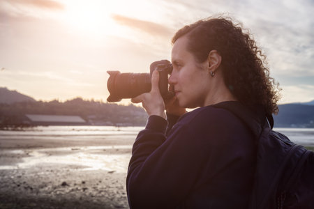 White Caucasian Adult Woman whos an Adventure Travel Photographer taking images of the City Park. Taken in Shoreline Trail, Port Moody, Greater Vancouver, British Columbia, Canada.の写真素材