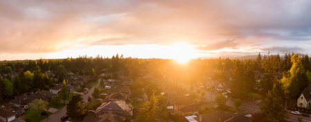 Aerial panoramic view of a suburban neighborhood during a vibrant and colorful sunset. Taken in Greater Vancouver, British Columbia, Canada.の写真素材