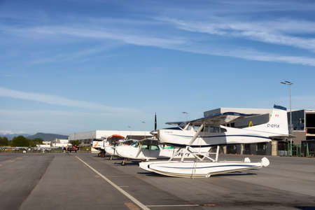 Pitt Meadows, Greater Vancouver, British Columbia, Canada - May 16, 2021: Airplanes parked at the Airport Apron during a sunny day.のeditorial素材