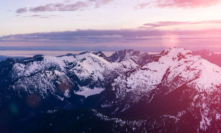 Aerial View from Airplane of Canadian Mountain Landscape in Spring time. Colorful Sunset Sky Art Render North of Vancouver, British Columbia, Canada.の写真素材
