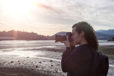White Caucasian Adult Woman whos an Adventure Travel Photographer taking images of the City Park. Taken in Shoreline Trail, Port Moody, Greater Vancouver, British Columbia, Canada.の写真素材