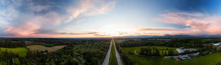 Aerial Panoramic View of Trans-Canada Highway 1 in Fraser Valley during colorful spring Sunset. Greater Vancouver, British Columbia, Canada.の写真素材