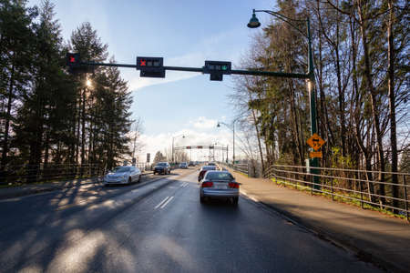 Vancouver, British Columbia, Canada - Dec 12, 2020: Drive across the famous Lions Gate Bridge in the modern Downtown City. Sunny Winter Day.のeditorial素材